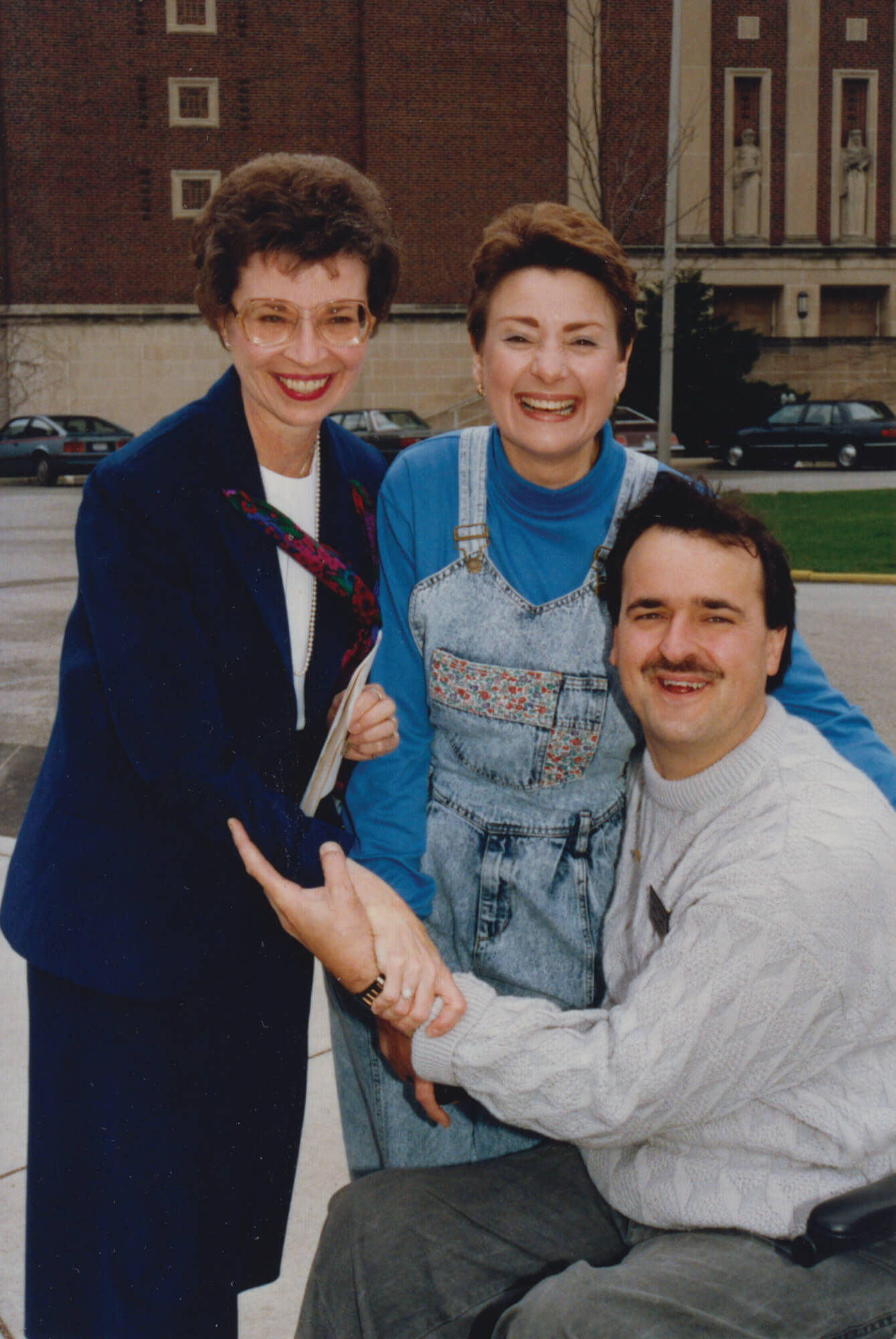 Dean of Students Betty M. Nelson with Greg Poorman and his wife,
Marty. Poorman was one of the first student wheelchair users to
graduate from Purdue. In 1978, Phi Kappa Tau devised the idea to help defray costs of making Purdue's campus accessible to all by selling curb cuts. The project was initiated by Poorman and David Huxhold.
Photo courtesy of 
Betty M. Nelson