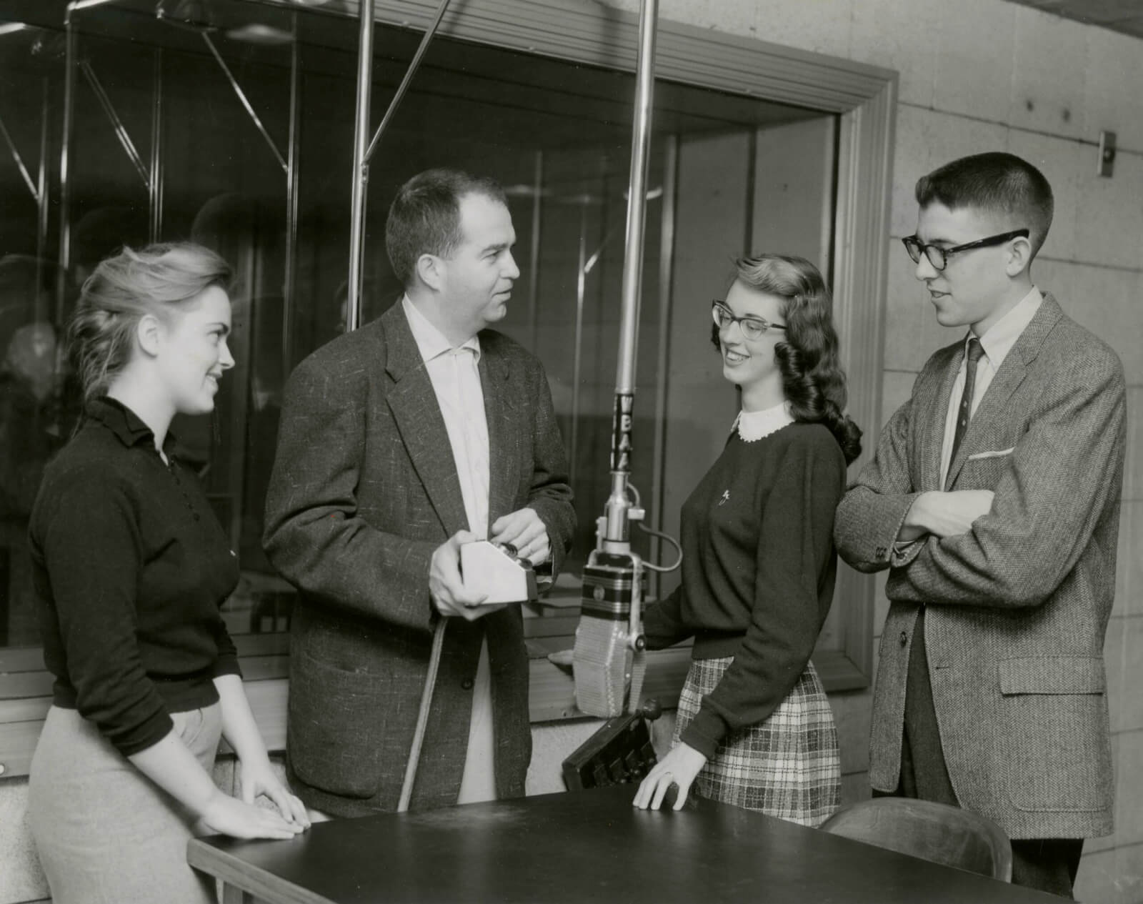 John DeCamp explains the workings of a cough box to members of the student WBAA Managing Board preparing to conduct tours during a January 1958 open house.