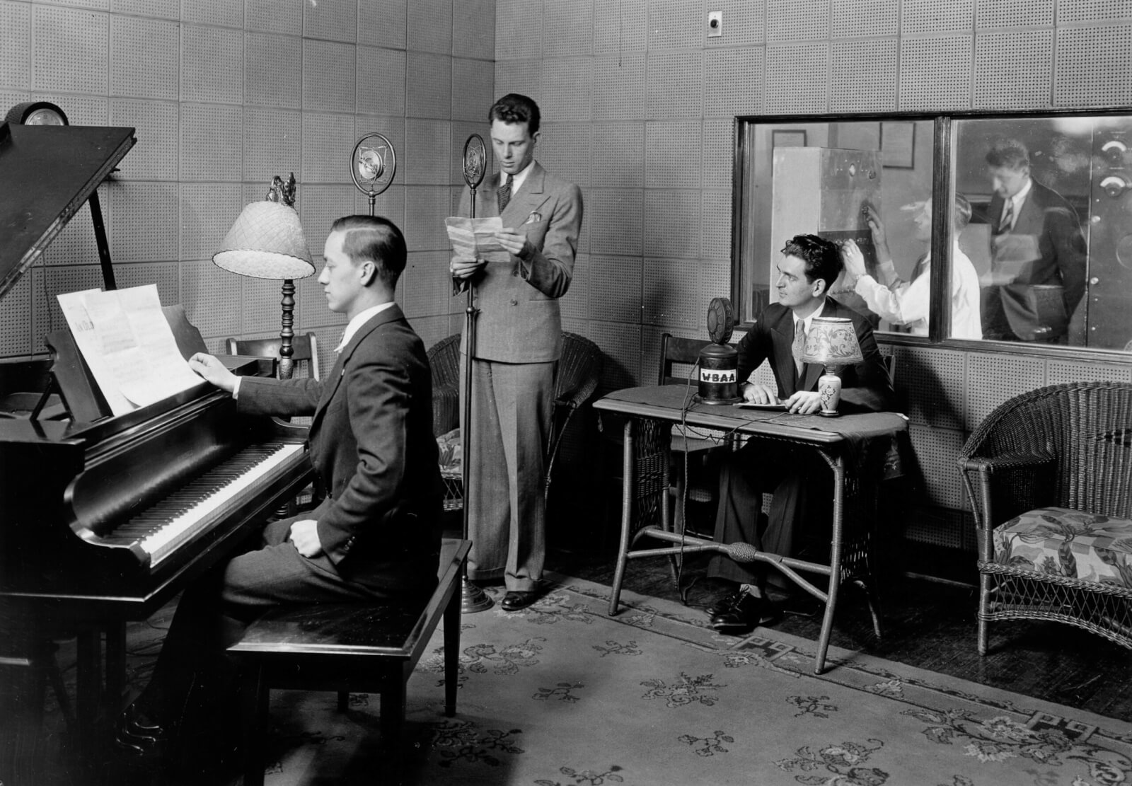 Wicker furniture, a tapestry rug and grand piano gave the 1934 studio a homey look.