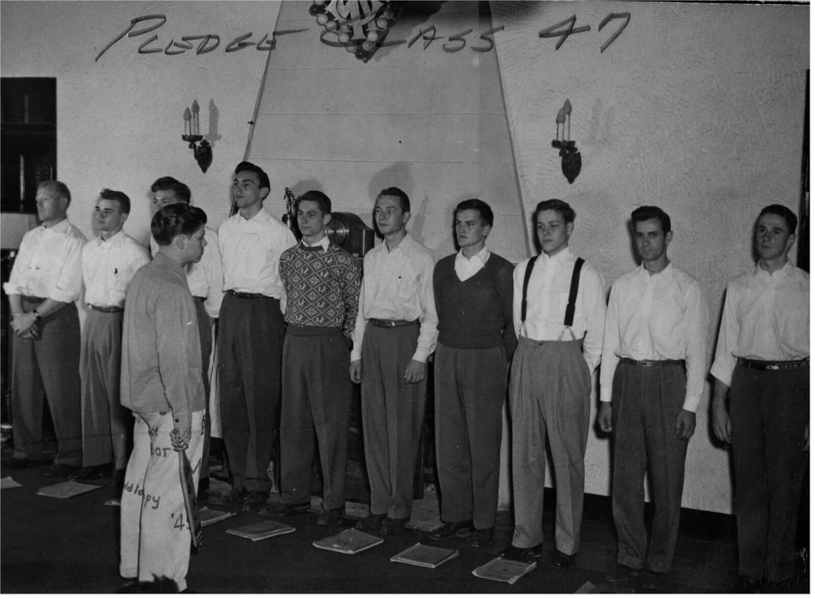 Circa 1947.  An old tradition was for the pledges to "line Up" in front of the actives after a chapter meeting.  They would be questioned on thier knowledge of brtohers bios, chapter history, traditions and other pledge "knowledge."  Note the pledge notebooks on the floor.