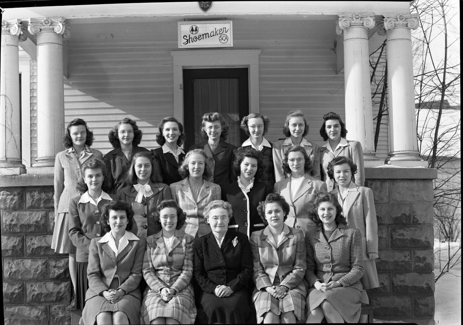 Members of Shoemaker Cooperative, originally called Twin Pines, pose with their housemother. 